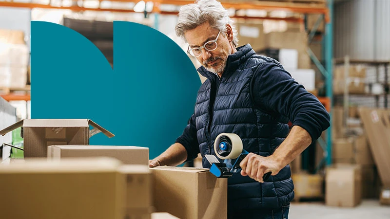 A small business owner packing an order, with teal geometric branding.