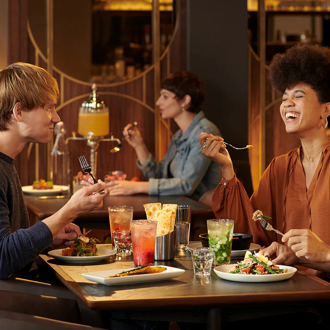 Photograph of guests seated at a cafe table.