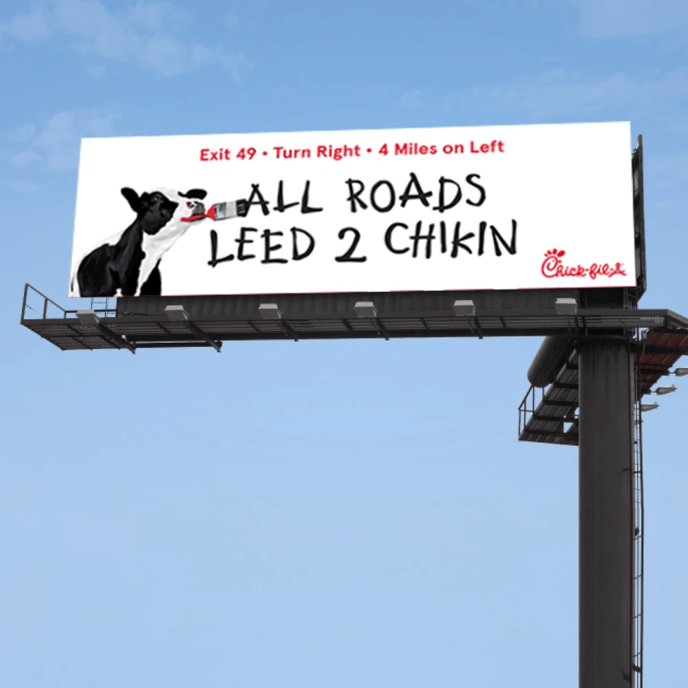 All roads leed 2 chikin artwork shown on an outdoor billboard