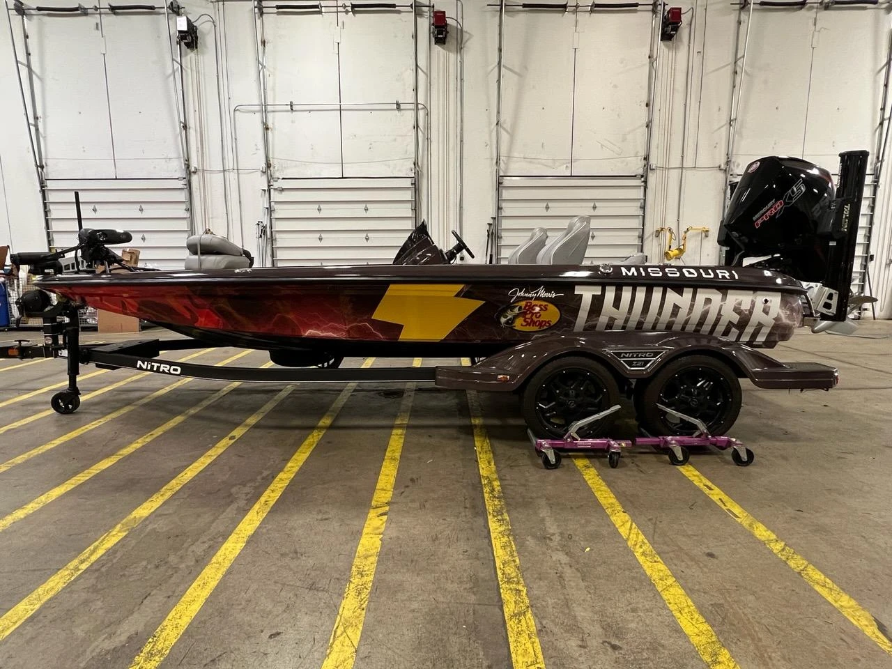 Side view of the branded Missouri Thunder boat in a workshop.