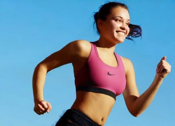 AI-generated athlete wearing the pink sports bra outdoors.